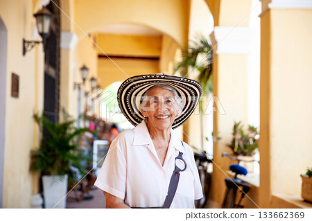 Senior travel. Senior woman at the beautiful heritage town of Mompox wearing the traditional Sombrero vueltiao. 133662369
