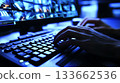 A person is typing on a computer keyboard with a blue screen behind them 133662536