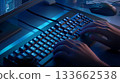 A person is typing on a computer keyboard with a blue background 133662538