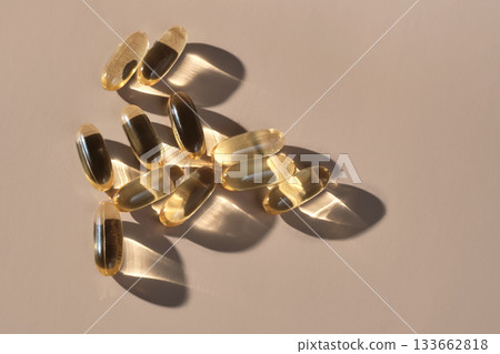 Golden omega 3 capsules in direct sunlight 133662818