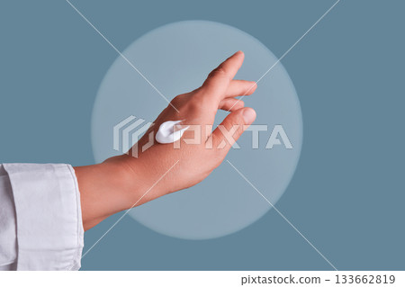 Hand applying moisturizing cream for skin health Hand applying moisturizing cream for skin health 133662819