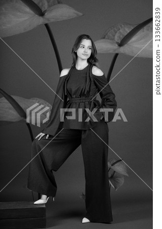 Beautiful woman with dark linen suit studio portrait in Anthurium flowers background Beautiful woman with dark linen suit studio portrait in Anthurium flowers background 133662839