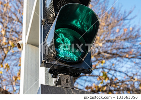 Green Traffic Light Against Clear Sky Green Traffic Light Against Clear Sky 133663356