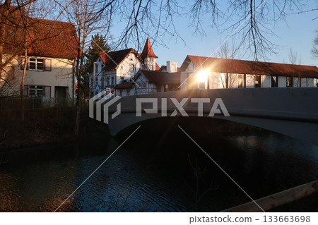 A bridge over a river with a house in the background A bridge over a river with a house in the background 133663698