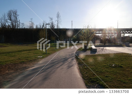 A park with a path and a bench 133663708