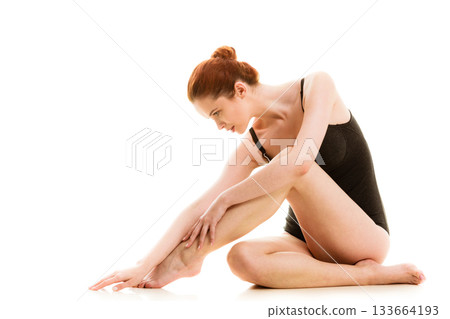 Sitting woman in underwear showing smooth legs Sitting woman in underwear showing smooth legs 133664193