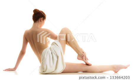 Sitting naked woman in white towel Sitting naked woman in white towel 133664203