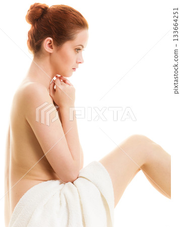 Sitting naked woman in white towel 133664251