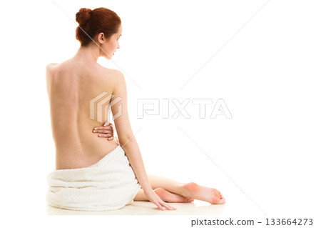 Sitting naked woman in white towel Sitting naked woman in white towel 133664273