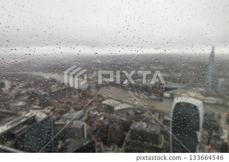 Blurred Cityscape of London with Raindrops on Glass 133664546