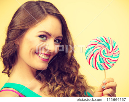Woman charming girl with lollipop candy 133664567