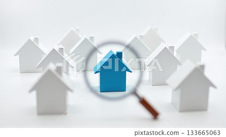 House with magnifier among white homes for property search - ai generated 133665063