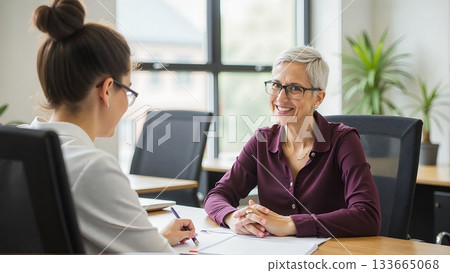 A student sits with the principal, discussing academic performance, future goals, and potential pathways to success A student sits with the principal, discussing academic performance, future goals, and potential pathways to success 133665068