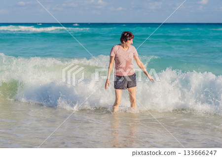 Elderly woman spending relaxing time on the beach, enjoying the ocean breeze and warm sunlight. Concept of active aging, mindfulness, serenity, healthy lifestyle, and peaceful coastal living Elderly woman spending relaxing time on the beach, enjoying the ocean breeze and warm sunlight. Concept of active aging, mindfulness, serenity, healthy lifestyle, and peaceful coastal living 133666247