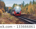 Diesel train moves in the autumn forest. 133666861
