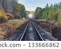 Diesel train moves in the autumn forest. 133666862