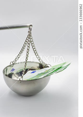 100 Euro banknotes on balance scale symbolizing financial justice concept. 133666962