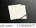 桌上放著黑色信紙和原子筆。 133666977