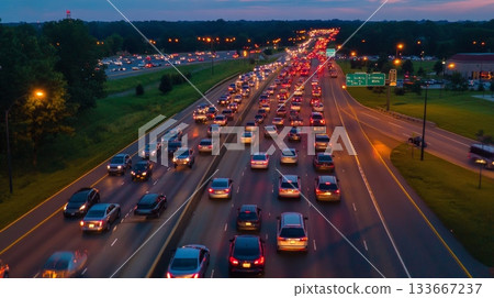 Numerous cars are caught in a traffic jam on a highway at dusk, emphasizing ongoing transportation challenges and the persistent issues of congestion during peak commute hours Numerous cars are caught in a traffic jam on a highway at dusk, emphasizing ongoing transportation challenges and the persistent issues of congestion during peak commute hours 133667237