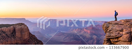 Backpacker enjoying breathtaking colorful sunrise over grand canyon national park in arizona, celebrating the beauty of vast landscape and exploring the wilderness 133667900