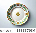 Fine dining. Ceramic plate with a green and gold pattern on a white background. Porcelain kitchenware. Close-up. Top view. 133667936