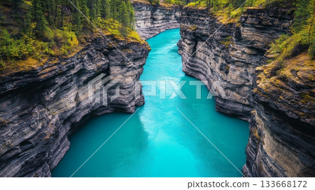 Breathtaking aerial view of the turquoise water of the yukon river winding through the steep cliffs of miles canyon, showcasing the raw beauty of the yukon territory's natural landscape 133668172