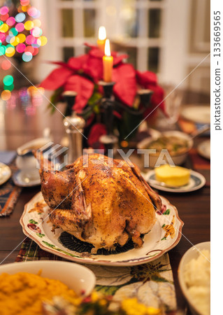 Christmas roasted turkey served on a festive holiday table with candles, poinsettia, colorful lights, and traditional side dishes. Christmas roasted turkey served on a festive holiday table with candles, poinsettia, colorful lights, and traditional side dishes. 133669565