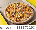 Fresh Gourmet Pizza in Open Box with Vibrant Toppings 133671193