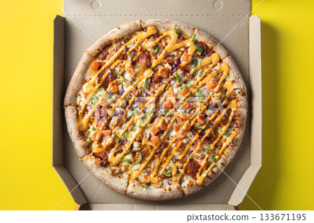 Top View of Fresh Pizza in Open Takeout Box on Yellow Background 133671195