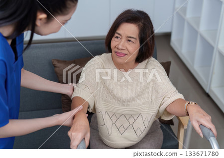 Healthcare. Nurse assisting elderly woman to stand, promoting mobility and care. Healthcare. Nurse assisting elderly woman to stand, promoting mobility and care. 133671780