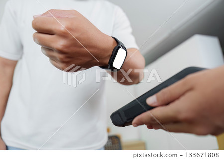 Smart technology. Man checking smartwatch notifications at home. 133671808