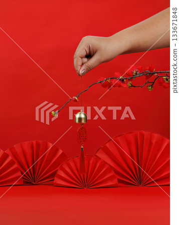 Chinese New Year celebration with red decorations and a golden bell 133671848
