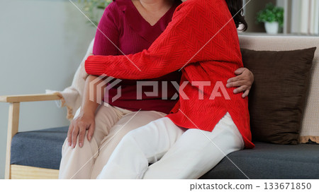 Affectionate Moment Between Mother and Daughter on Sofa 133671850