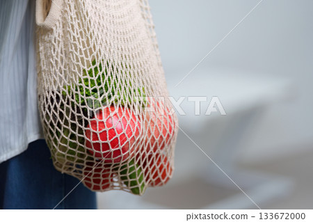 Sustainable Living. Eco-friendly shopping with reusable bag filled with fresh vegetables. Sustainable Living. Eco-friendly shopping with reusable bag filled with fresh vegetables. 133672000