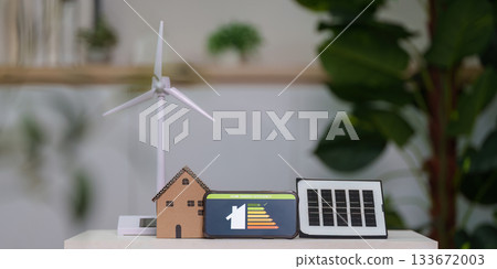Sustainable Energy Solutions. Display of wind turbine and solar panel models. Sustainable Energy Solutions. Display of wind turbine and solar panel models. 133672003