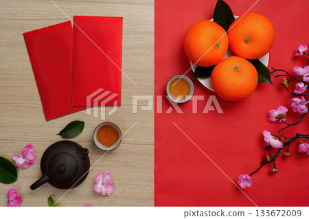 Chinese New Year festive arrangement with red envelopes, oranges, and tea Chinese New Year festive arrangement with red envelopes, oranges, and tea 133672009