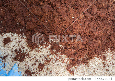 Coconut coir and rice husk while blending for making potting soil. Fertilizers help improve soil fertility, boost plant growth, and increase agricultural productivity. 133672021