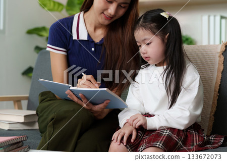 Nurturing Education: Mother and Daughter Engaged in Learning 133672073
