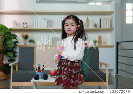Back to School. Young girl with backpack preparing for school in modern home setting. Back to School. Young girl with backpack preparing for school in modern home setting. 133672079