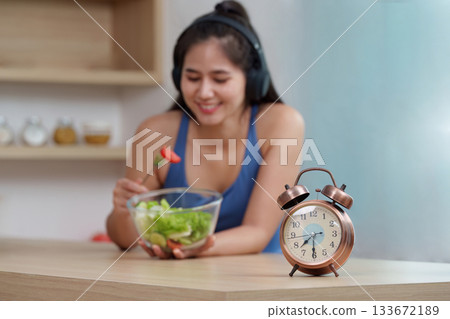 Food Wellness: Enjoying a Healthy Salad with a Timer for Mindful Eating Food Wellness: Enjoying a Healthy Salad with a Timer for Mindful Eating 133672189