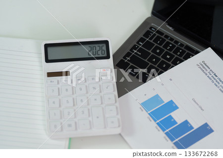 Financial Planning. Calculator and laptop on a desk for budget analysis and reporting. 133672268