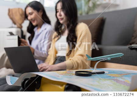 Travel Planning: Friends researching destinations with laptop and map Travel Planning: Friends researching destinations with laptop and map 133672274