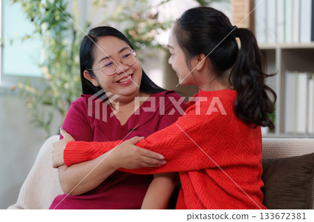 Mother and Daughter Sharing a Warm Embrace at Home 133672381