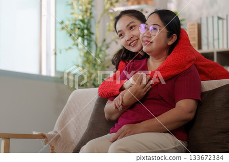 Emotional connection. Young woman embracing her mother, showcasing love and support. 133672384