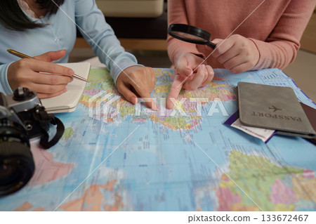 Travel Planning. Friends examining a map for their next trip. Travel Planning. Friends examining a map for their next trip. 133672467