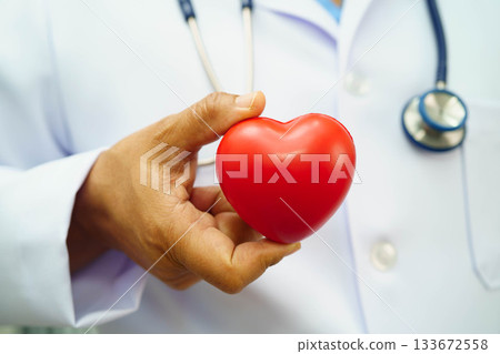 Asian woman doctor holding red heart for health in hospital. Asian woman doctor holding red heart for health in hospital. 133672558