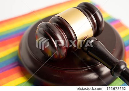 Gavel for judge lawyer on rainbow flag, symbol of LGBT pride month. Gavel for judge lawyer on rainbow flag, symbol of LGBT pride month. 133672562