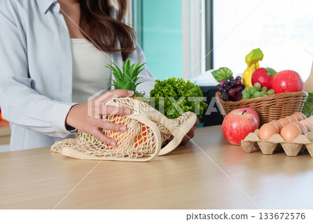 Sustainability. Eco-friendly shopping with reusable bag filled with fresh produce. 133672576