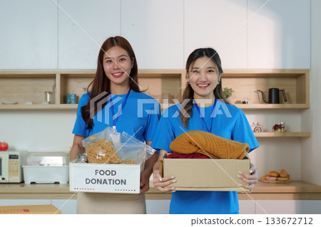 Women Holding Donation Boxes: Community Spirit and Generosity Women Holding Donation Boxes: Community Spirit and Generosity 133672712