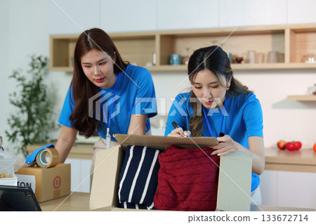 Donation Sorting. Volunteers organizing clothing donations for community outreach. 133672714